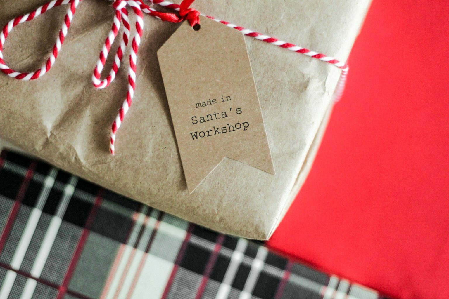 a gold and red ribbon on a red and white checkered surface