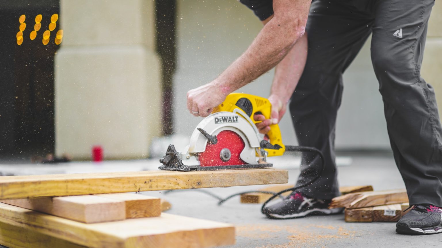 a man cutting a piece of wood