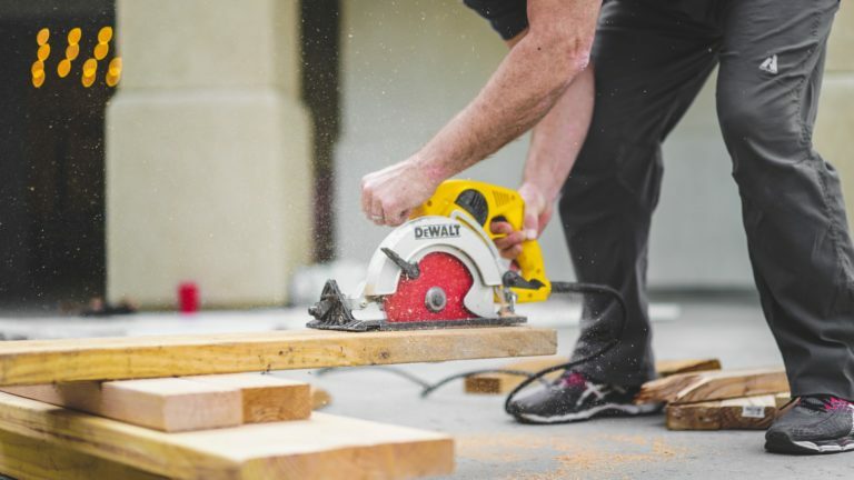 a man cutting a piece of wood