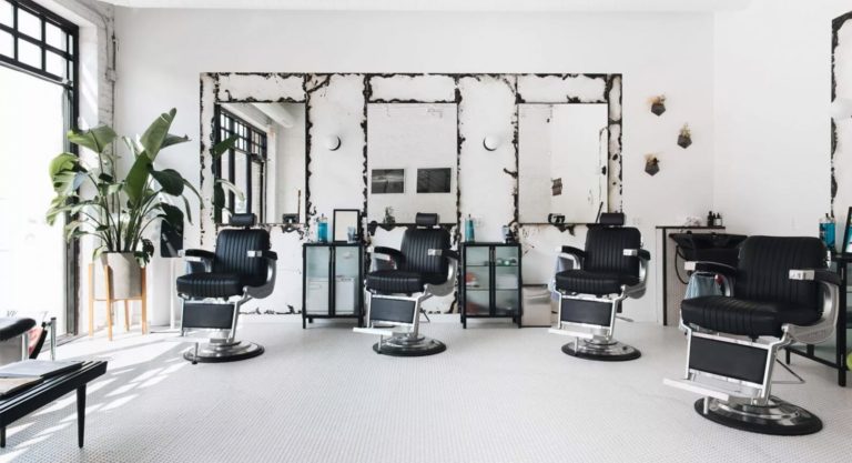 a room with a desk and chairs