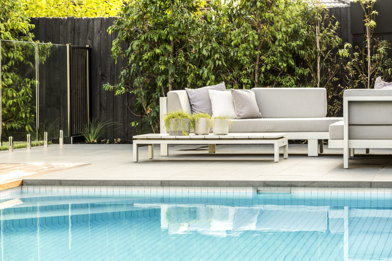 a couch next to a pool