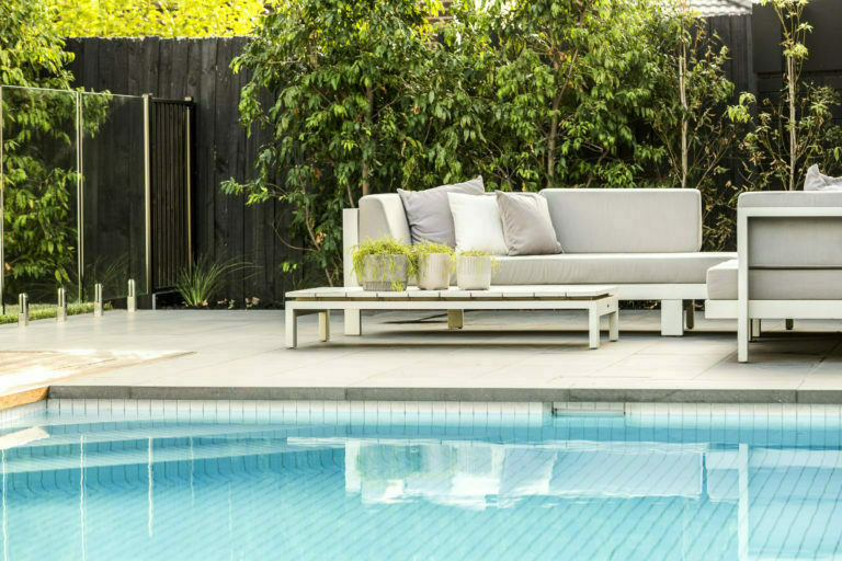 a couch next to a pool