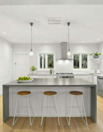 a kitchen with stools and a island