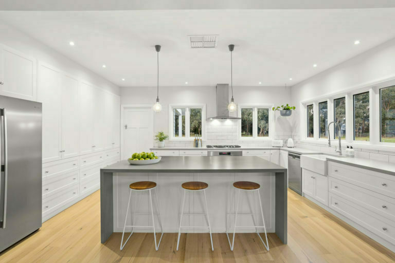 a kitchen with stools and a island